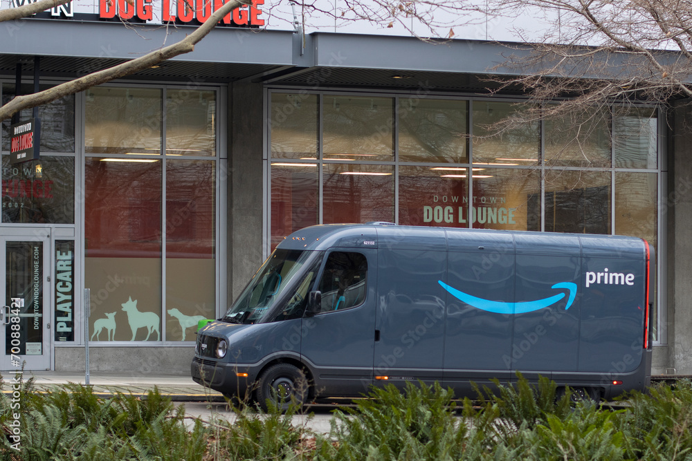 Amazon electric delivery van parked outside a storefront